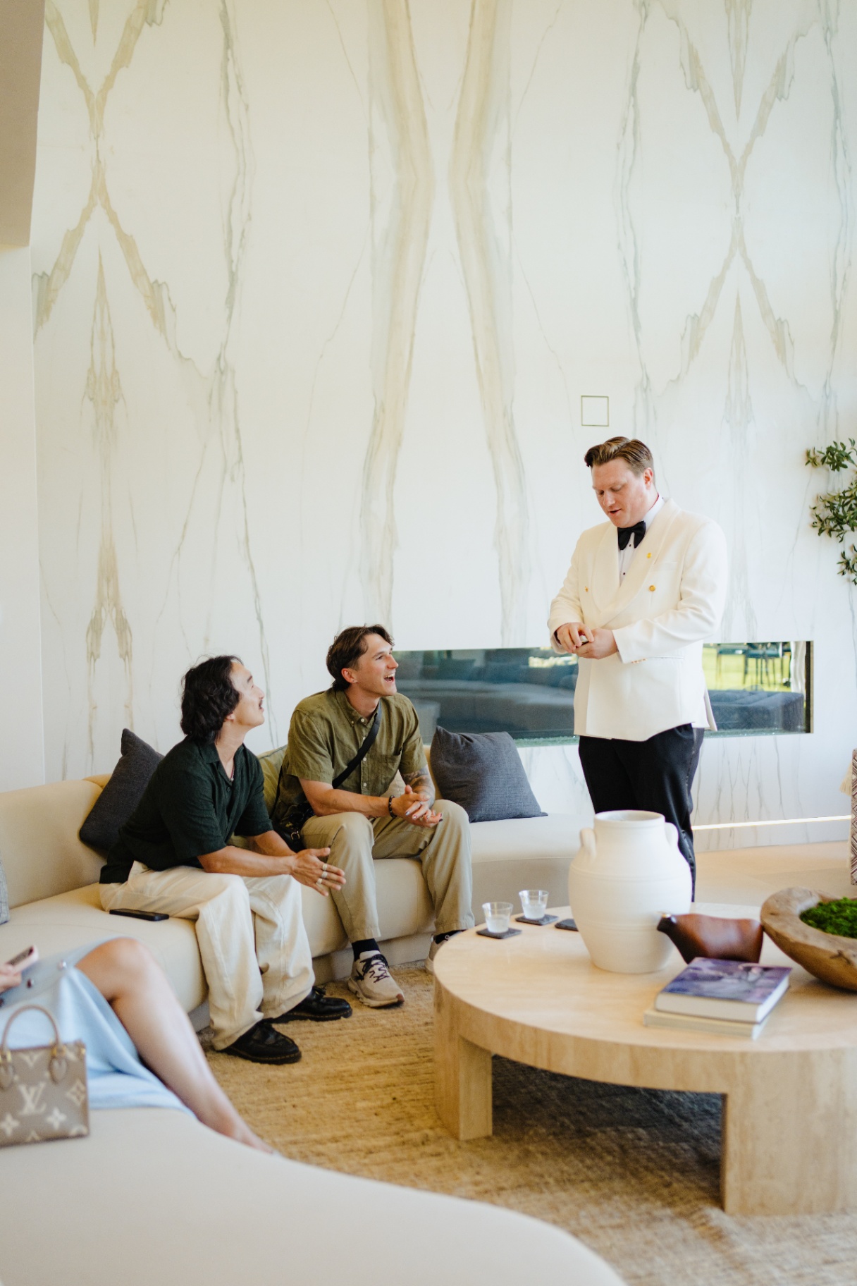 Scott Syme performing close-up magic for guests in a luxury Los Angeles living room