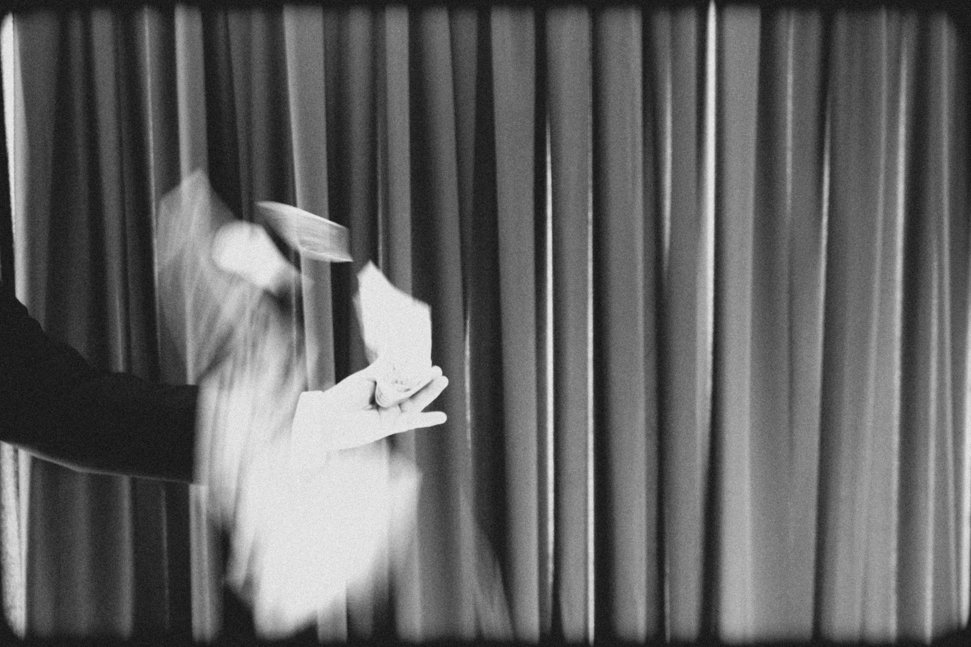 Playing cards in motion against emerald curtain backdrop