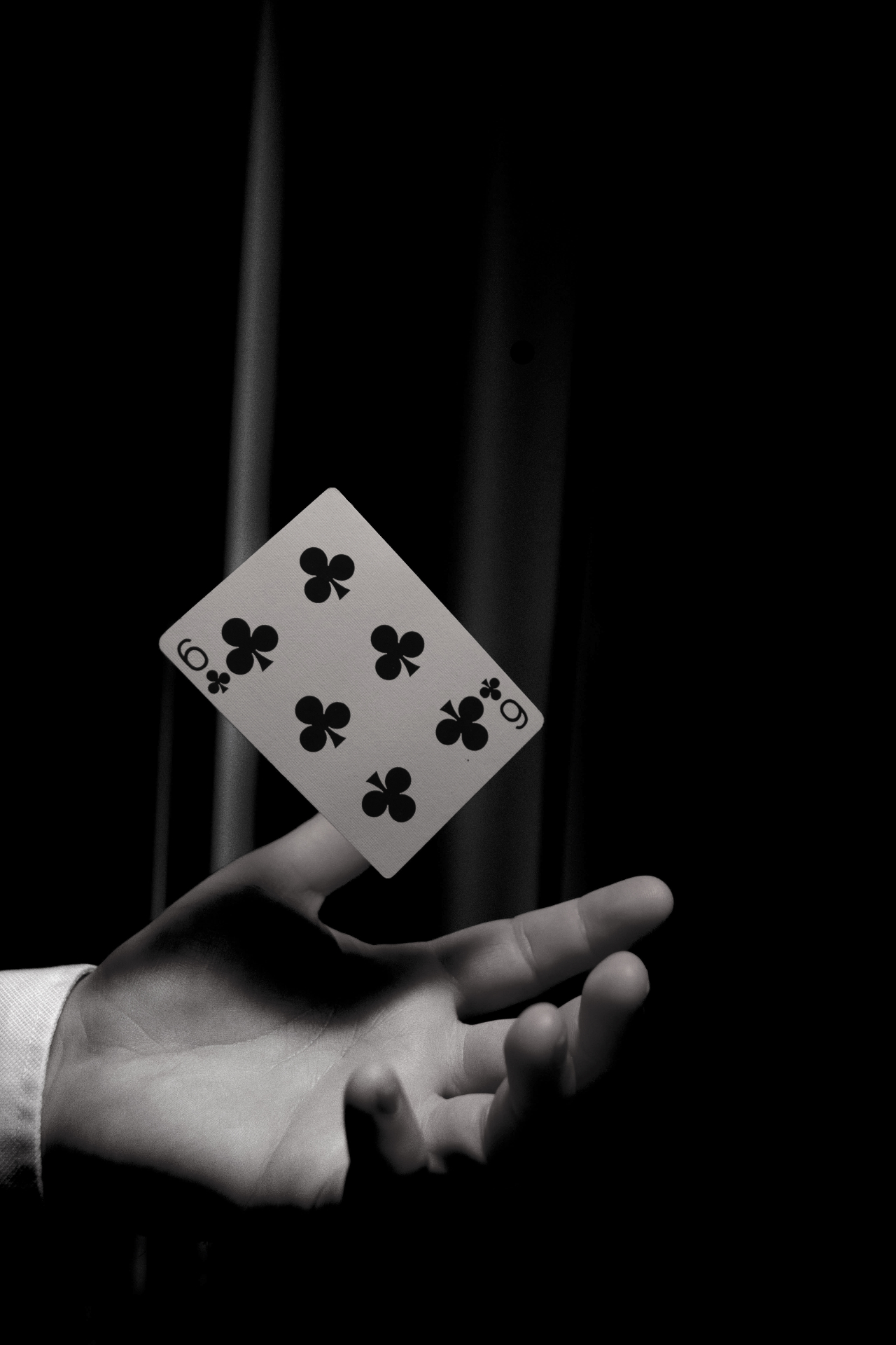 Playing card suspended in mid-air during a corporate event performance