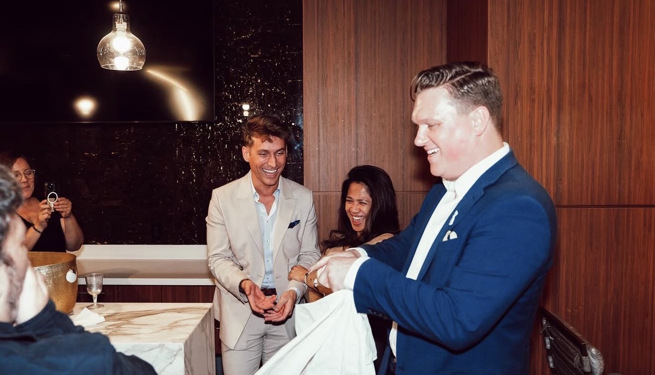 Scott Syme performing close-up magic at a luxury restaurant event