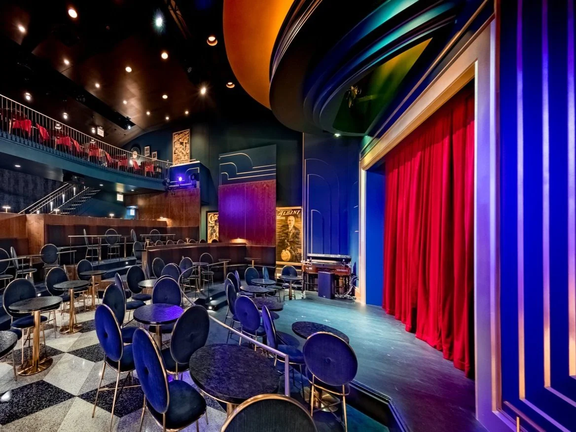 The Chicago Magic Lounge signature showroom with velvet seating and red curtain stage